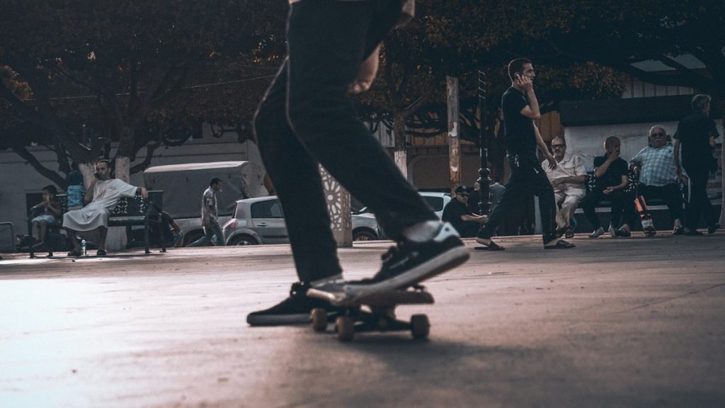 man playing skateboard at night