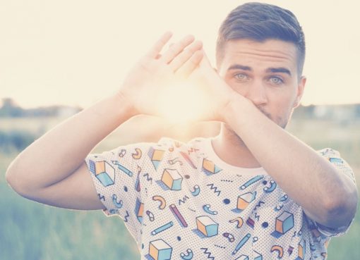 Man with green eyes holding the sun